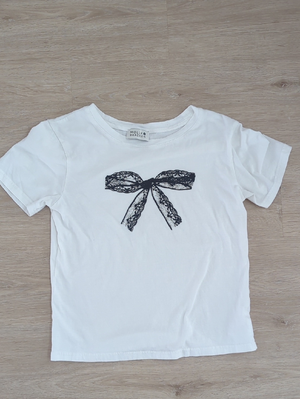 Molly Bracken White Tee with Black Lace Bow Graphic